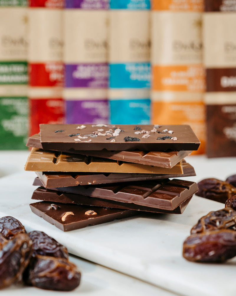 Variety of all our date sweetened vegan chocolate bars stacked together as part of our discounted variety pack